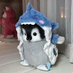 a stuffed animal that is wearing a blue and white hat on it's head