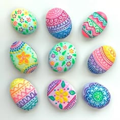 colorful painted rocks arranged on a white surface