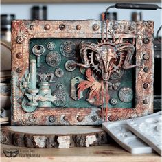 an old metal box sitting on top of a wooden table