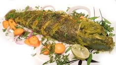 green fish fry with vegetables on a white plate