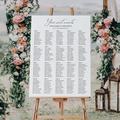 a sign with flowers and greenery on it that says your wedding date is displayed in front of an easel