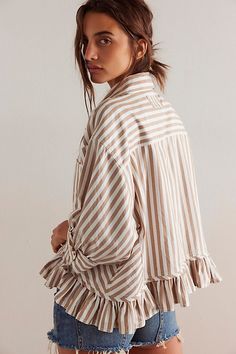 A feminine take on the classic button-down, this shirt from our We The Free collection is featured in a striped fabrication and collared-neckline with ¾ sleeves. **Fit:** Relaxed fit, hip-length style **Features:** Striped cotton fabrication, collared-neckline, button-front closures, drop-shoulder ¾ sleeves with cuffs, ruffled hem **Why We ❤ It:** This top is a fun twist on the classic menswear silhouette. | We The Free Bailey Stripe Shirt at Free People in Tan, Size: XL Fun Collared Shirts, Spring Tops With Vertical Stripes And Spread Collar, Vertical Stripes Long Sleeve Top For Day Out, Chic Vertical Stripes Blouse For Day Out, Vertical Striped Shirt For Day Out In Spring, Collared Tops With Vertical Stripes For Fall, Striped Collared Blouse Relaxed Fit, Spring Striped Relaxed Fit Blouse, Striped Collared Blouse With Relaxed Fit