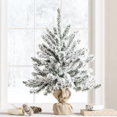 a white christmas tree with snow on it