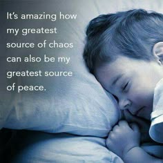 a young boy sleeping on top of a white pillow