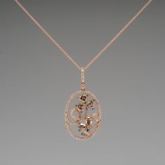 This gorgeous Carlo Viani necklace is crafted of 14k rose gold and features a floral diamond motif. The pendant is set with 6 fancy brown pear cut diamonds, 2 fancy brown round brilliant diamonds, and 94 smaller round brilliant accent diamonds. The total diamond weight is 1.89 carats. The pendant is in excellent condition and hangs from a 14k rose gold 18-inch chain. Ask us about a matching Carlo Viani ring. Luxury Oval Diamond Necklace With Rose Cut, Luxury Brown Jewelry With Brilliant Cut, Elegant Oval Brown Jewelry, Elegant Brown Oval Jewelry, Luxury Diamond Necklace With Rose Cut Flower Pendant, Luxury Brown Jewelry With Diamond Accents, Luxury Rose Cut Diamond Flower Pendant Necklace, Elegant Brown Jewelry, Luxury Rose Gold Diamond Necklace With Rose Cut Diamonds