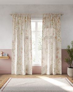 a living room with pink walls, white curtains and a rug in front of the window