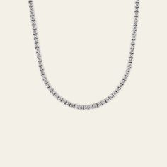 Everyone needs a perfect diamond tennis necklace in their accessory rotation. This 20-inch diamond line necklace with 15.50 carats of diamonds is just the piece to add to your wardrobe. You can dress it for a formal black-tie event or keep it super casual by layering with a colorful, beaded chain. This unisex piece will truly become your jewelry MVP. Details18K White Gold160 Round Cut Diamonds15.50 CaratsDiamonds Weigh Approximately 0.10 Carats EachLength: 20 Inches Timeless Silver Tennis Necklace With Diamond Accents, Formal Silver Diamond Tennis Necklace, Classic Diamond White Tennis Necklace For Everyday Luxury, Classic Cubic Zirconia Tennis Necklace For Formal Occasions, Classic Cubic Zirconia Tennis Necklace, Classic Single Strand Cubic Zirconia Tennis Necklace, Timeless Silver Single Strand Tennis Necklace, Formal Tennis Necklace With Single Cut Diamonds, Classic Diamond Cut Tennis Necklace For Formal Occasions