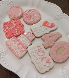 a white plate topped with decorated cookies on top of a table