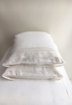 three white pillows stacked on top of each other