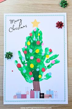 a handprinted christmas tree card on a table