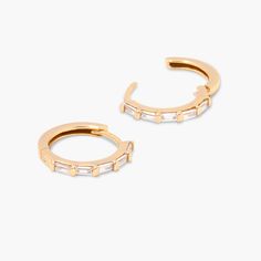 Discover effortless elegance with Elliana Hoops. Crafted from 14k gold, these hoops add the perfect touch of sparkle to any look. Feel confident and beautiful with these timeless earrings - are you ready to shine? Available in 14k gold plated sterling silver Hoop size: 5/8" Hoop width: 1mm Baguette CZ: 1.5mmx3mm Hinged closure Protected with an anti-tarnish barrier SKU: BYE1137 Gold Small Hoop Diamond Earrings In Sterling Silver, Gold Hoop Earrings With Prong Setting, Small Hoop Yellow Gold Cubic Zirconia Earrings, Gold Hoop Earrings With Prong Setting For Everyday, Everyday Gold Hoop Diamond Earrings, Rose Gold Small Hoop Earrings With Cubic Zirconia, Small Rose Gold Cubic Zirconia Hoop Earrings, Everyday Small Hoop Earrings, Gold Hypoallergenic Hoop Diamond Earrings