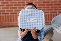 This stylish lunch bag is perfect for toting your lunch to school. With its cool blue gingham print, it'll make a statement wherever your kiddo goes. Pack their day with some deliciousness – it’s the perfect accessory for the lunchroom! Care Instructions: -Hand wash -Spot clean -Lay flat to dry 10 x 12 x3 Insulated Preppy Blue School Bags, Blue Rectangular Picnic Bags, Preppy Gingham Rectangular Bags, Preppy Gingham Rectangular Bag, Preppy Rectangular Gingham Bag, Gingham Bags For Travel And Back To School, Back To School Travel Bags In Gingham, Back To School Gingham Travel Bags, Cute Blue Rectangular Lunch Bag