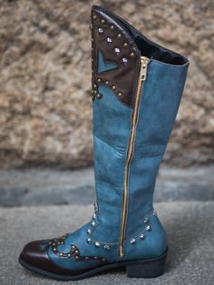 Embrace your country roots with these vibrant cowboy boots boasting an edgy boot harness and intricate studded. A sturdy rubber sole ensures a confident step. 1.8" heel Zip closure 13.2'' shaft 15.8'' circumference Man-made PU upper Man-made lining Man-made footbed Man-made midsole Rubber sole Western Blue Leather Heeled Boots, Blue Leather Western Heeled Boots, Western Style Blue Leather Heeled Boots, Turquoise Leather Boots For Western-themed Events, Blue Leather Heeled Boots With Snip Toe, Blue Western Boots For Western-themed Events, Western Style Blue Festival Boots, Blue Western Style Festival Boots, Blue Western Festival Boots