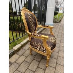 a leopard print chair sitting on top of a sidewalk