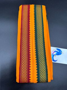 Red & Orange color cotton Angavastram with maroon and green combination borders on both sides This is only Angavastram with out Dhoti/ Pancha Handmade item  Hand loom cotton  size: 1.8 meters  🌸 C A R E . T I P S  🌸 We don't want your special moments to fade. To maintain the quality of your products , please : - Avoid contact with perfumes, other chemicals, including household cleaners. - Do not use chemical jewelry cleaners. - Gently polish with a soft, lint-free cloth after every use. Please do not use a metal polishing cloth. - Store your beloved products in a cool dry place. O U R . P R O M I S E   We believe that customer satisfaction is our utmost priority. So all our products are quality checked, compactly packed and safely shipped so that it reaches you in perfect condition. D I Traditional Wear With Motifs For Puja During Navratri, Handloom Cotton Fabric For Festivals, Multicolor Traditional Wear For Puja With Cutdana, Multicolor Traditional Wear With Cutdana For Puja, Multicolor Cutdana Traditional Wear For Puja, Multicolor Cotton Traditional Wear For Diwali, Traditional Kurta For Navratri Puja, Traditional Kurta With Woven Motifs For Ceremonies, Traditional Kurta For Diwali Rituals