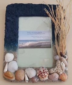 a photo frame with sea shells on it