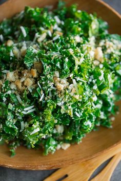 a wooden bowl filled with chopped green vegetables