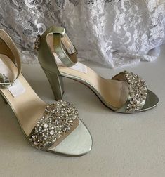 a pair of women's high heeled shoes with jewel embellishments