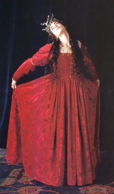 a woman in a red dress with a crown on her head