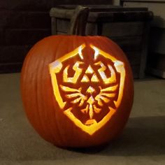 a carved pumpkin with the legend of zelda emblem on it