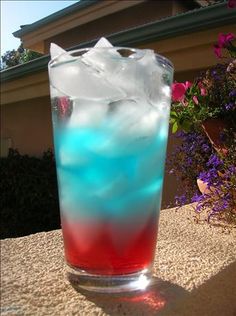 a tall glass filled with blue and red liquid