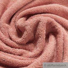 an image of a pink towel textured in closeup on a bed or couch