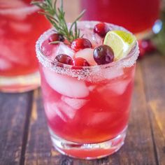 two glasses filled with cranberry margaritas on top of a table