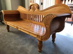 a wooden bench sitting in the middle of a room