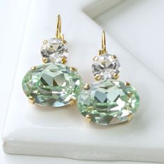 Fresh Light Green Swarovski Crystal Ovals with Clear Crystals on Top, Dangle Lever Back Earrings in Gold, Crystal Drop Earrings in Gold Crystal Ball Earrings, Swarovski Crystal Drop Earrings, Clear Crystal Earrings, Emerald Earrings Drop, Bridesmaid Earrings Gold, Blue Crystal Earrings, Gold Bridesmaids, Bridesmaid Gifts Jewelry, Green Oval