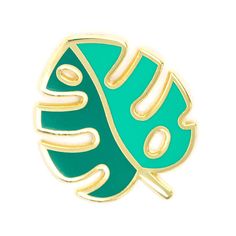 a green and gold pin with the word love on it's center, sitting in front of a white background