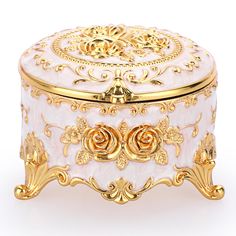 a white and gold decorated box on a white background