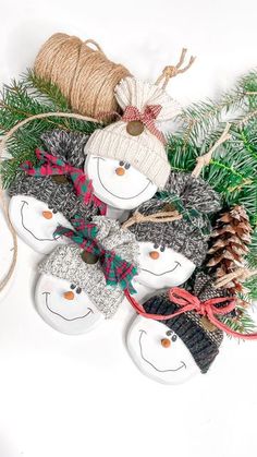 snowman ornament with pine cones and twine on white background for decoration