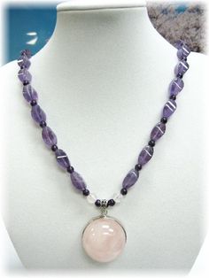 "This is a high grade piece of necklace consisting of 26 pcs of high clarity violet Amethyst which are being spaced in between with round 3mm deep purple Amethyst beads. The high graded Rose Quartz hemisphere shaped pendant is encased in 925 silver rim and bail.  The entire necklace measures 19\" and ends beautifully with a set of 925 silver toggle. This item will come to you in a beautifully packaged box suitable for gift giving. A LITTLE FACT ABOUT AMETHYST: The colours of the amethyst - from Amethyst Crystal Necklaces With Round Pendant, Faceted Amethyst Healing Necklace, Spiritual Faceted Amethyst Crystal Necklace, Lavender Round Jewelry With Faceted Beads, Spiritual Crystal Necklace With Faceted Beads, Spiritual Purple Faceted Necklace, Lavender Crystal Necklaces With Round Beads, Purple Amethyst Round Bead Necklaces, Amethyst Faceted Beads Jewelry