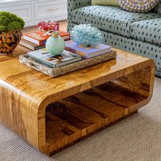 a coffee table with books on it in front of a couch