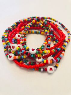 Single Bracelet made of seed beads. Made on stretch cord with cute heart bead in center. Option of Red or Rainbow and Option on size 6 inch or 7 inch. Please reach out if you need a customization. Playful Heart Beads Stretch Bracelet, Heart-shaped Beaded Bracelets With Tiny Beads For Friendship, Heart-shaped Beaded Stretch Bracelet For Friendship, Heart-shaped Tiny Beaded Bracelets For Friendship, Playful Friendship Bracelets With Heart Beads, Multicolor Letter Beads Bracelets For Valentine's Day, Red Heart-shaped Bracelet With Colorful Beads, Red Letter Beads For Friendship, Adjustable Beaded Stretch Bracelet For Valentine's Day