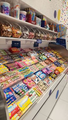 a display in a store filled with lots of different types of snacks and candy bars