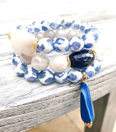 Beautiful mixture of blues, cremes and whites in this bracelet set to include a teardrop faceted jade charm, a deep rich blue focal stone and a creamy white rectangle focal stone. Elegant Blue Stretch Bracelet With Natural Stones, Luxury Blue Oyster Bracelet Jewelry, Bohemian Blue Gemstone Bracelets, Elegant Blue Stackable Crystal Bracelet, Bohemian Blue Faceted Bracelet, Elegant Blue Amazonite Bracelets, Elegant Blue Multi-strand Bracelets, Jade Charm, Creamy White