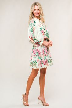 A printed woven mini dress featuring ruffled neckline with front tie, long sleeve, elasticized waist and ruffled hemline Details: Self : 100% PolyesterLining: 100% Polyester Size & Fit - Model is 5`7" And Wearing Size Small- Measurements Taken From Size Small- Approx. Length: 35" Summer Blouson Sleeves Mini Dress For Daywear, Vacation Long Sleeve Dress With Blouson Sleeves, Long Sleeve Dresses With Blouson Sleeves For Vacation, Spring Mini Dress With Elastic Sleeves For Day Out, Spring Mini Dress With Blouson Sleeves For Brunch, Casual Vacation Dresses With Blouson Sleeves, Casual Summer Dress With Blouson Sleeves, Casual Dresses With Blouson Sleeves For Vacation, Brunch Mini Dress With Smocked Cuffs