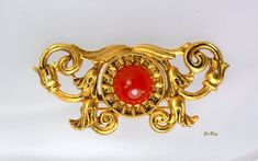 "Beautiful Vintage Victorian Revival style 24 karat antique gold-plate over pewter bar brooch with Carnelian  cabochon. It is almost 2 1/4\" long and 1\" high. The cabochon is 1/4\" in diameter. Very interesting and detailed brooch in excellent condition.  We combine shipping, If you want to take advantage of the reduced shipping you must contact us before you pay for your items so we can send you a corrected invoice.  Thank You for visiting our Etsy store https://www.etsy.com/shop/VictoryIssweet !" Art Nouveau Gold Brooch With Cabochon, Vintage Gold Intaglio Brooches, Antique Gold Intaglio Brooches, Ornate Gold Cabochon Brooches, Ceremonial Gold Cabochon Brooches, Collectible Gold Cabochon Brooches, Antique Gold Brooches With Cabochon, Antique Gold Brooch With Cabochon, Antique Gold Brooch With Cabochon Detail