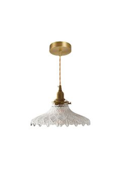 an antique brass and glass ceiling light with a white shade on the top, against a white background