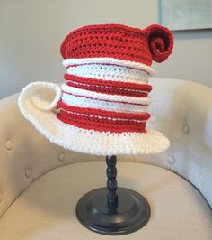 Hand crafted tilted red and white striped cat in a hat inspired steampunk top hat for all your costume needs.  Perfect for your upcoming school performances or raves.  This hat measures approximately 22 inches at the brim without being stretched, which will best fit an average sized adult. Please measure yourself accordingly. Hat is double stranded for extra stiffness and durability and will have slightly less stretch than other styles. Item is made of 100% Acrylic yarn and double stranded to give it a little extra stiffness to maintain its shape.   *Pattern adaptation credit to crochetverse. Themed Fitted Hat For Cosplay, Red Brimmed Hat For Costume, Themed Red Costume Hat, Red Themed Hat For Costume Party, Fitted Hat With Curved Brim For Cosplay, Fitted Curved Brim Hat For Cosplay, Fitted Brimmed Hat For Cosplay, Hat Cosplay, Steampunk Top