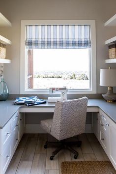 a chair sitting in front of a window on top of a desk