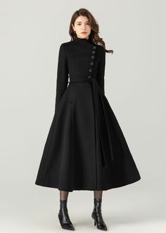 FEATURES 50% wool, 50% wool blend Fully liner with polyester Two pockets Stand up neckline Long sleeve Button closure in front Tie belt waist For Winter, Autumn Long wool coat Black wool coat dry clean ★★Mode size Height 170cm (5′ 7″)  Bust 84 cm (33")  Waist 66 cm (26")  She wears size XS. ★★Bespoke Order Service If you Request other color Request the length Your height is not between 155 cm- 175 cm Your weight is not between 47 kg -77 kg I can do it for you, It will need some extra fee depending on on your need. Contact with me for more detail. ★★ Warmly Note: 1 ) : Please confirm your shipping address! If you wish to ship the item to a different address, please send me a message immediately after purchase. We can't change it after shipping, thank you for your understanding. 2 ) : Due to Chic A-line Wool Coat For Work, Chic A-line Wool Outerwear, Formal A-line Wool Coat For Fall, Fitted Belted Wool Coat For Winter, Chic Stand Collar Wool Coat For Winter, Chic Wool Coat With Stand Collar For Winter, Wool A-line Outerwear For Fall, A-line Wool Outerwear For Fall, A-line Outerwear For Winter Workwear