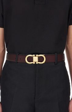 A high-polish Gancio buckle brings Ferragamo's signature motif to the front of a belt crafted for simplicity and distinction from glossy black leather. Leather Made in Italy Designer Calf Leather Belt Buckle, Designer Calf Leather Belt Buckles, Designer Belts With Buckle Closure For Business, Luxury Belts With Rectangular Buckle, Luxury Belts With Rectangular Buckle Closure, Luxury Business Belt With Gold Buckle, Luxury Business Belts With Gold Buckle, Designer Business Belts With Gold Buckle, Luxury Belts With Buckle Closure For Formal Occasions