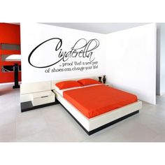 there is a bedroom with red walls and white furniture in the room that has an orange bed