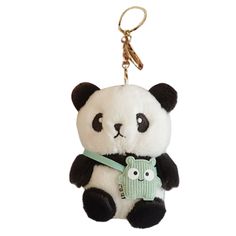 a panda bear keychain with a green tag hanging from it's side