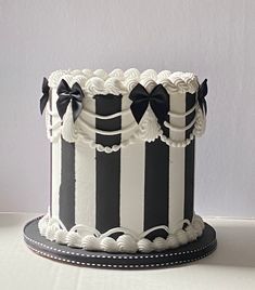 a black and white striped cake sitting on top of a table