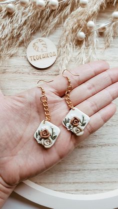 "CLAY FLORAL EARRINGS | BOHO ROSE EARRINGS, FLOWER CLAY EARRINS, GIFTS FOR HER, BRIDAL EARRINGS, VALENTINES DAY EARRINGS, BRIDAL FAVORS, BRIDESMAID GIFTS Welcome! ♥ With this listing you will receive (1) pair of these super cute CLAY ROSE earrings. They are a beautiful color blend of brown, cream, and white flowers.  These are light weight, semi flexible clay, not heavy hard clay.  Super cute and perfect with just about any outfit! Or perfect gift! ♥ Style: Boho | Beachy | Minimalist | Plant lover ♥ These measure at about: 2.5\" including the ear hook ♥ Materials:  Gold plated ear hooks ♥ CUSTOM ORDERS are welcomed! Send me a message so we can work together on creating something just for you ( or for that someone special ♥) ♥ If you have any questions, please message me! And I will be happ Elegant Adjustable Rose Design Earrings, Handmade Flower Dangle Earrings In Polymer Clay, Handmade Flower Dangle Jewelry In Polymer Clay, Flower Shaped Earrings With Rose Design For Gift, Flower-shaped Rose Design Earrings For Gift, Handmade Rose Gold Flower Dangle Earrings, Flower Shaped Rose Design Earrings For Gifts, Flower Rose Design Earrings As Gift, Rose Design Flower Earrings As Gift