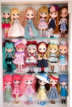 a shelf filled with lots of little dolls