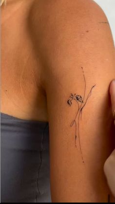 a woman's arm with a tattoo on it and a flower in the middle